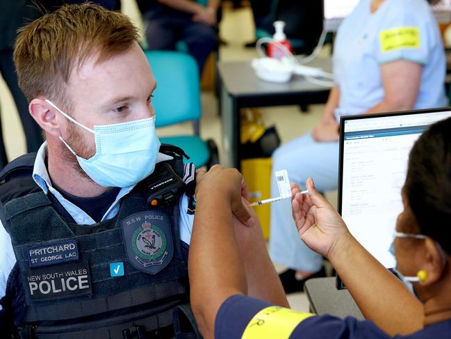 POOL PHOTOS - NSW front line health and emergency workers are amongst the first in NSW to get the Covid-19 vaccination at the Royal Prince Alfred Hospital Vaccination Hub in Camperdown. Police officer Lachlan Pritchard is the second person in NSW to receive the Pfizer vaccine. Picture: Toby Zerna