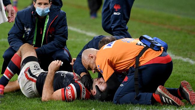 James Tedesco receives attention after being knocked down by Maika Sivo. Picture: Dan Himbrechts/AAP