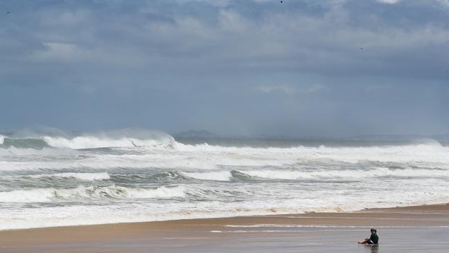 Tourists and locals watch on as giant surf pounds Gold Coasts northern beaches. Picture Glenn Hampson