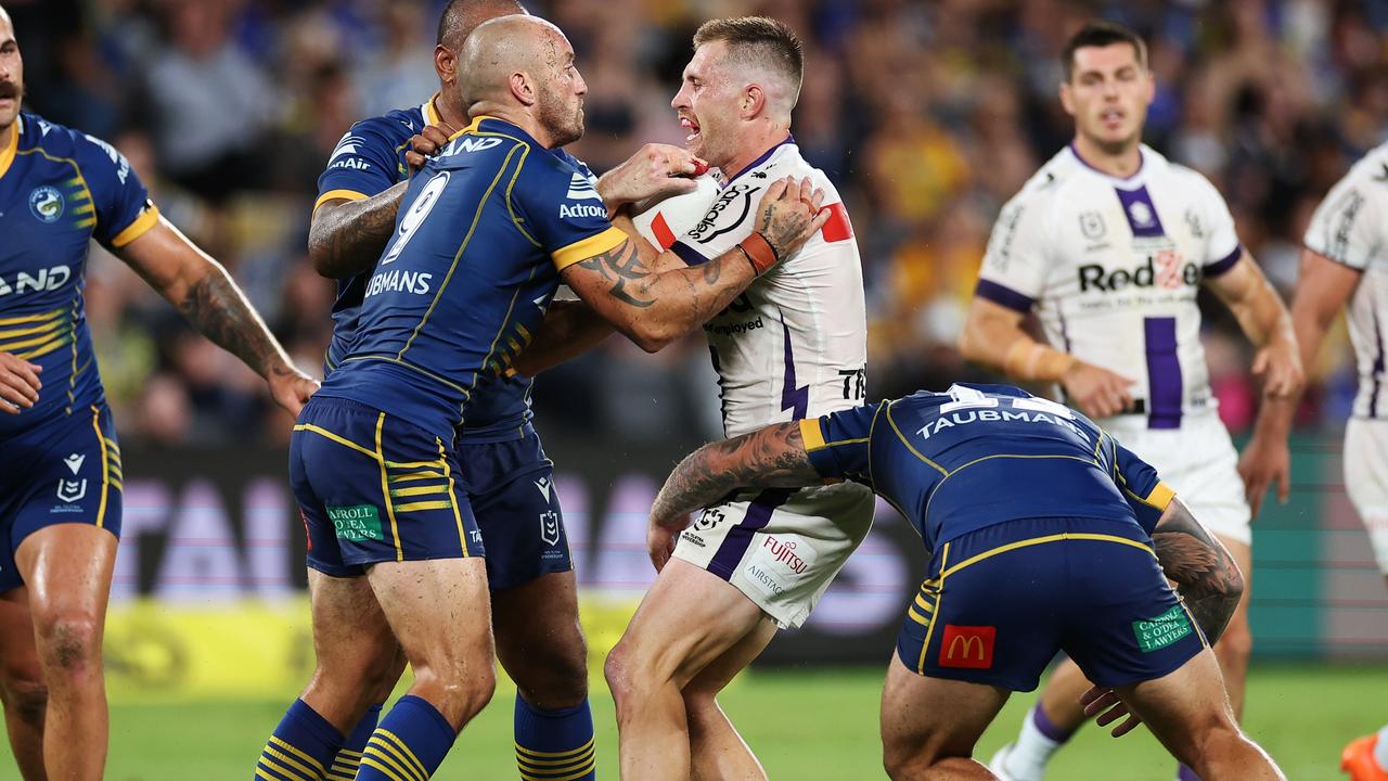 SYDNEY, AUSTRALIA - MARCH 02: Cameron Munster of the Storm is tackled during the round one NRL match between the Parramatta Eels and the Melbourne Storm at CommBank Stadium on March 02, 2023 in Sydney, Australia. (Photo by Cameron Spencer/Getty Images)