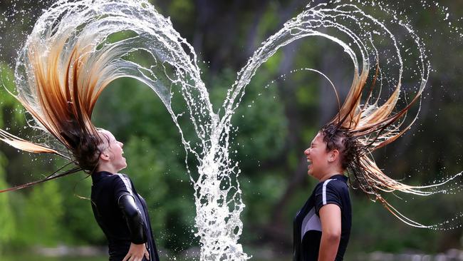 Amelia and Cheniqua, both 13, cool off in the Ovens River at Wangaratta after school. Picture: Alex Coppel