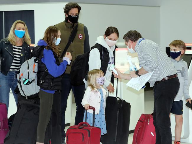 AFL CEO Gillon McLachlan and his family leave on the last flight to Brisbane. Picture: Alex Coppel.