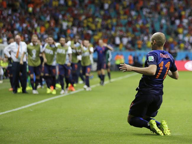 Netherlands' Arjen Robben drops to his knees after scoring his side's second goal during the second half of the group B World Cup  match against Spain.