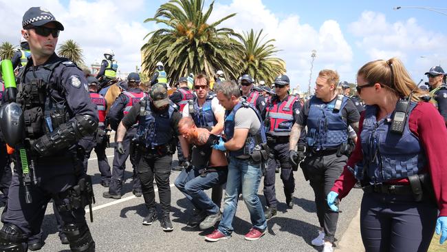 Police drag along a detained man at the St Kilda immigration protests on Saturday. Picture: Matrix