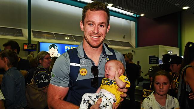 Michael Morgan holds six-week-old Kyriarna Oxlee at Townsville Airport on Sunday. Picture: Zak Simmonds