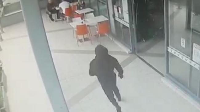 CCTV captures Walid Ahmad’s killer approaching as he dines with his bodyguard.