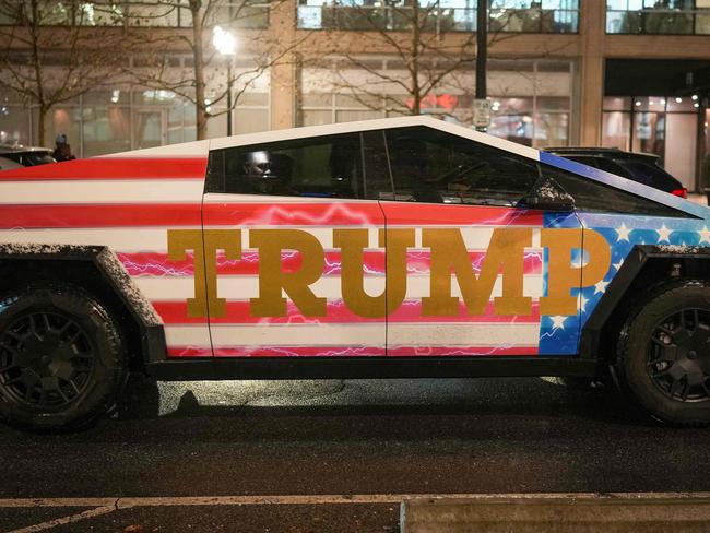 WASHINGTON, DC - JANUARY 19: A Donald Trump-adorned Tesla Cybertruck sits in traffic on January 19, 2025 in Washington, DC. U.S. President-elect Donald Trump and Vice President-elect JD Vance will be sworn in on January 20.   Christopher Furlong/Getty Images/AFP (Photo by Christopher Furlong / GETTY IMAGES NORTH AMERICA / Getty Images via AFP)