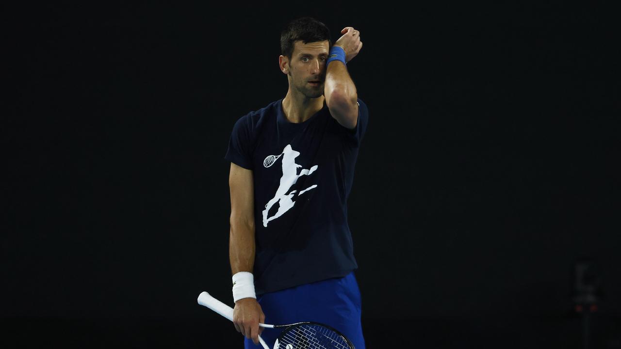 MELBOURNE, AUSTRALIA - JANUARY 14: Novak Djokovic of Serbia wipes sweat during a practice session ahead of the 2022 Australian Open at Melbourne Park on January 14, 2022 in Melbourne, Australia. (Photo by Daniel Pockett/Getty Images)