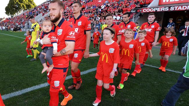 Adelaide United take to the field with their children during the round 20 A-League match between the Reds and the Central Coast Mariners at Coopers Stadium. Picture:  Mark Brake / Getty