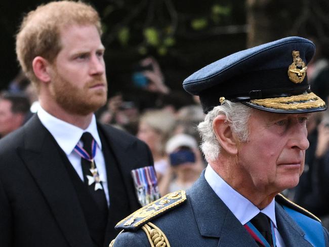 TOPSHOT - Britain's King Charles III and Britain's Prince Harry, Duke of Sussex walk behind the coffin of Queen Elizabeth II, adorned with a Royal Standard and the Imperial State Crown and pulled by a Gun Carriage of The King's Troop Royal Horse Artillery, during a procession from Buckingham Palace to the Palace of Westminster, in London on September 14, 2022. - Queen Elizabeth II will lie in state in Westminster Hall inside the Palace of Westminster, from Wednesday until a few hours before her funeral on Monday, with huge queues expected to file past her coffin to pay their respects. (Photo by LOIC VENANCE / AFP)