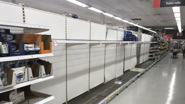 Empty shelves where toilet paper should be at the Coles store in Belmont Village.