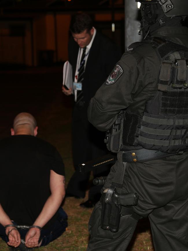 A man is held after a series of raids in Sydney by a MEOCS taskforce targeting drug and gun crime. File picture