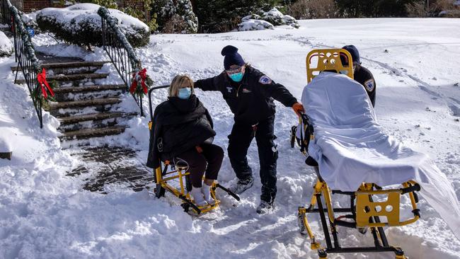 A woman suspected to have COVID-19 is transported to hospital in Yonkers, New York, as the big chill bites. Picture: AFP