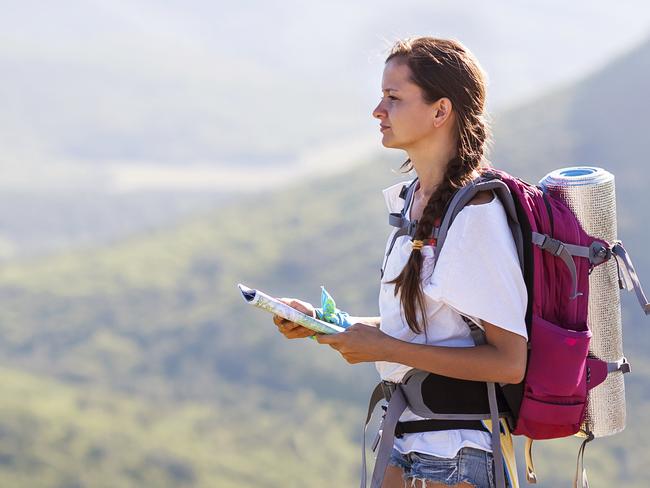 Young, beautiful girl with a backpack on her back