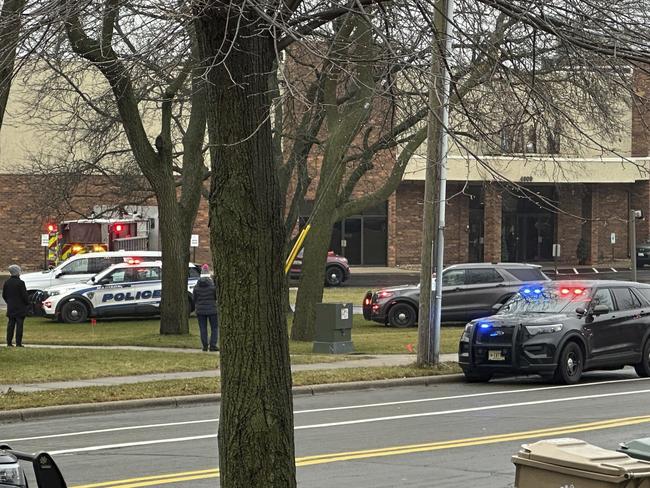 Emergency vehicles are parked outside the Abundant Life Christian School. Picture: AP