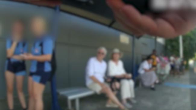 Task Force Guardian talk to Smithfield State High School students at a Spence St bus stop. Picture: Queensland Police