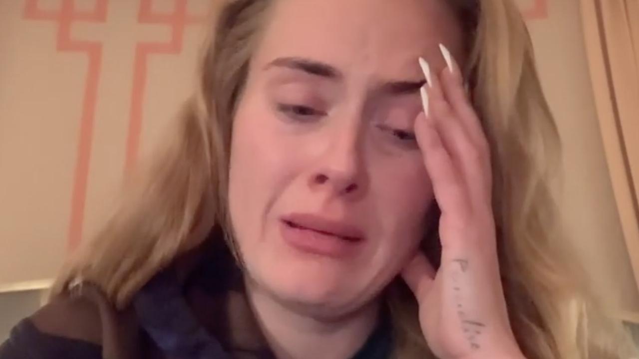 Adele breaks down as she makes the announcement.
