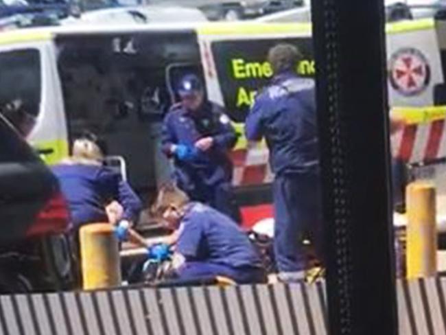 Paramedics work on Hawi in the car park.