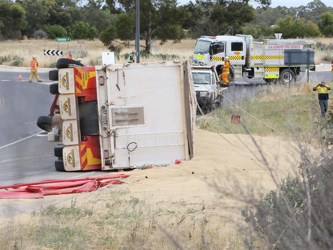 The truck rolled on its side spilling grain onto the road. Picture Emma Brasier