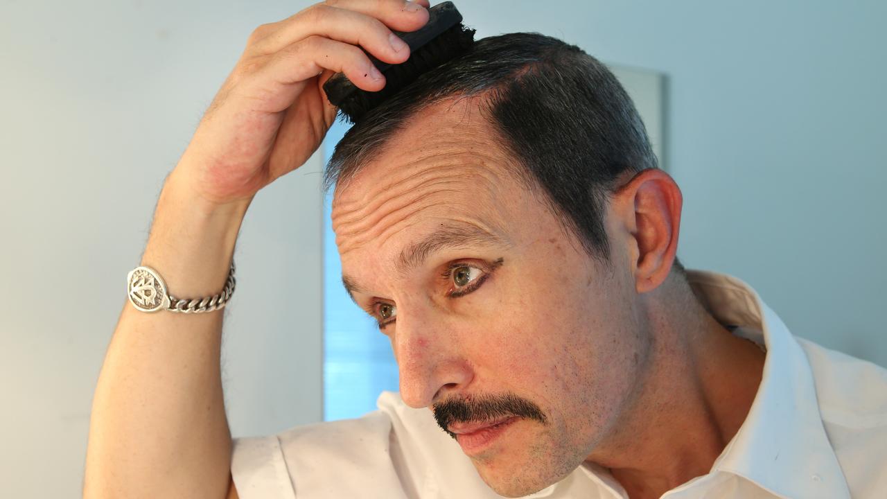 Gareth Hill applying the boot polish to become Freddie Mercury. Picture: David Caird