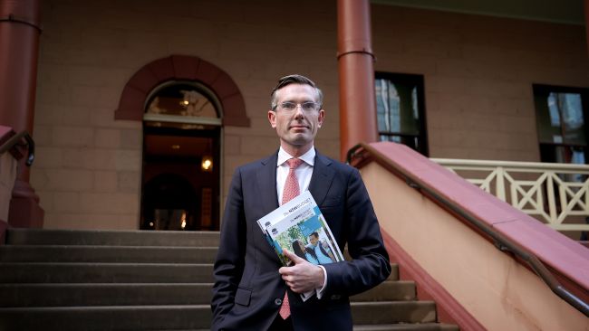 NSW Treasurer Dominic Perrottet holding the budget outside Parliament House in Sydney. Picture: NCA NewsWire / Dylan Coker