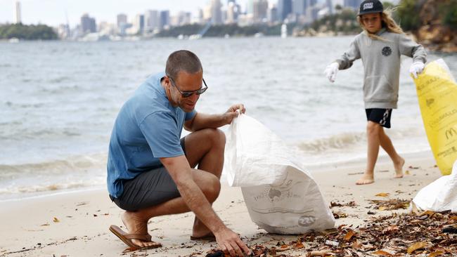 Early on Tuesday morning, Johnson and his touring crew caught a ferry to Whiting Beach, near the Taronga Zoo Wharf in Mosman. The secluded spot with postcard-perfect harbour views has for years been plagued by copious amounts of discarded plastics and rubbish. Picture: Richard Dobson