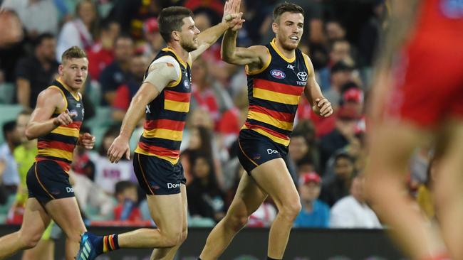 Paul Seedsman celebrates a goal with teammate Bryce Gibbs during Adelaide’s upset win against Sydney at the SCG. Picture: David Moir (AAP)