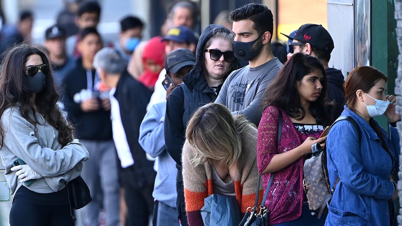 People queuing to enter Centrelink in Melbourne on March 24. The economy will go into a downturn when JobKeeper and JobSeeker are lowered after September. Picture: Quinn Rooney/Getty Images