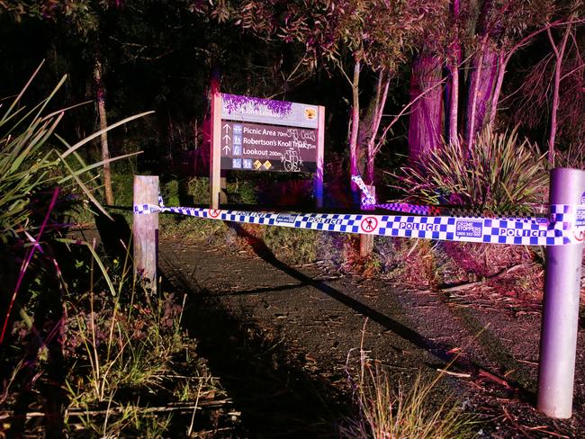 Police have cordoned off a track leading to Robertson Lookout at Mount Keira near Wollongong after a mother and child have fallen to their deaths. Picture: Richard Dobson