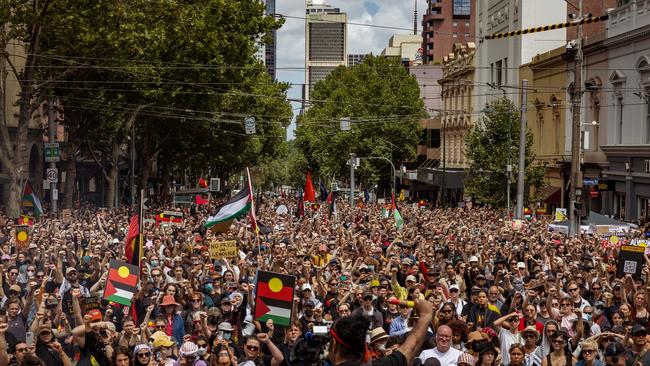 : The crowd holds up there fist during the Invasion Day Rally. (Photo by Tamati Smith/Getty Images)