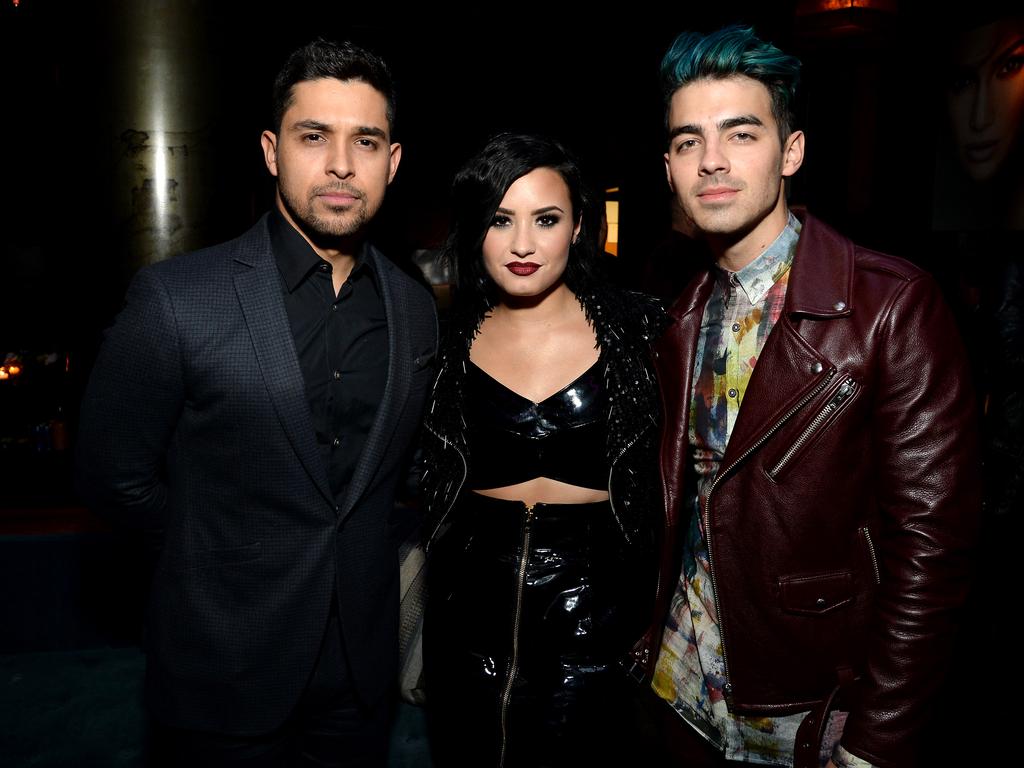 Wilmer Valderrama, Demi Lovato and Joe Jonas attend Jennifer Lopez’s 2015 American Music Awards After Party on November 22, 2015 in Los Angeles, California. Picture: Getty