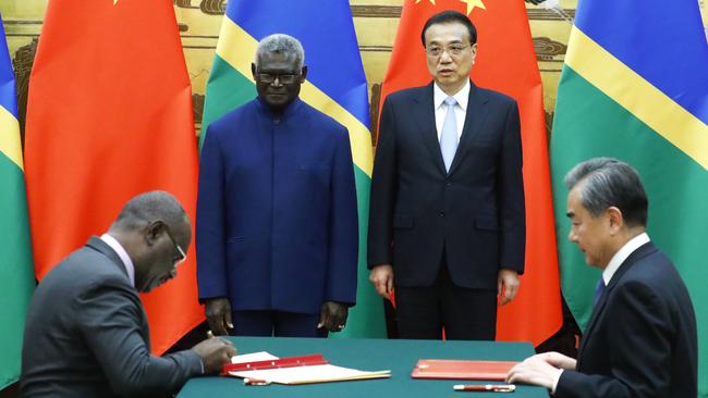 Solomon Islands Prime Minister Manasseh Sogavare, Solomon Islands Foreign Minister Jeremiah Manele, Chinese Premier Li Keqiang and Chinese State Councillor and Foreign Minister Wang Yi attend a signing ceremony at the Great Hall of the People on October 9, 2019 in Beijing.