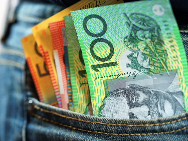 Australian cash money in mans jeans pocket, close up.