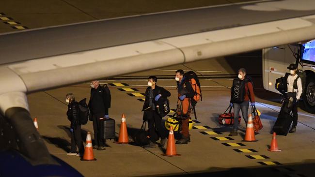 COVID-19-free passengers evacuated from the coronavirus-stricken Australian liner Greg Mortimer board the medically equipped plane that will fly Australian and New Zealander passengers to Melbourne.