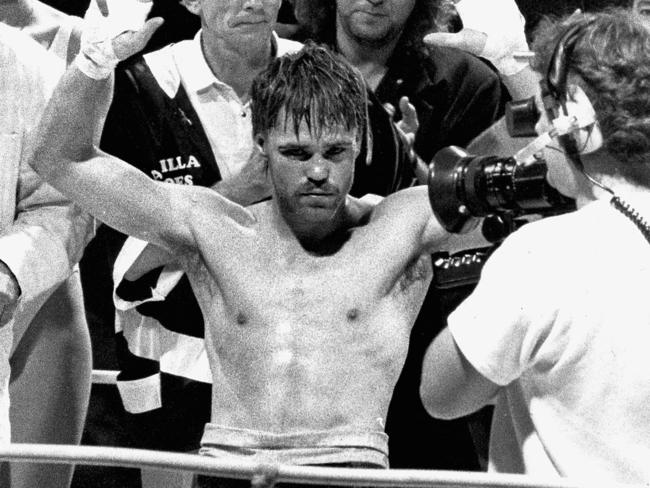 Boxing - Boxer Lester Ellis enjoys victory as a unamimous points decision goes his way after Commonwealth light welterweight title fight with Tony Laing at Apollo Entertainment Centre 04 Aug 1988. Behind him is Singer Jimmy Barnes. (Pic by staff photographer Ray Titus) LIB FILE: P Boxing - E