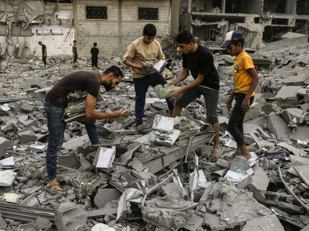 People salvage belongings from the rubble of a building levelled in an Israeli strike on Rafah in the southern Gaza Strip. Picture: AFP