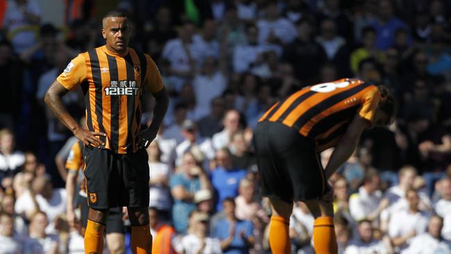 Hull City’s English midfielder Tom Huddlestone (L) reacts after the Tottenham scored.