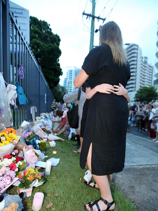 A mother comforts her daughter at a vigil for Charlise Mutten.