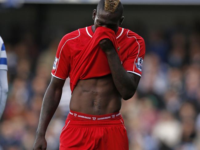 Liverpool's Italian striker Mario Balotelli reacts during the English Premier League football match between Queens Park Rangers and Liverpool at Loftus Road in London on October 19, 2014. AFP PHOTO / ADRIAN DENNIS RESTRICTED TO EDITORIAL USE. No use with unauthorized audio, video, data, fixture lists, club/league logos or “live” services. Online in-match use limited to 45 images, no video emulation. No use in betting, games or single club/league/player publications.