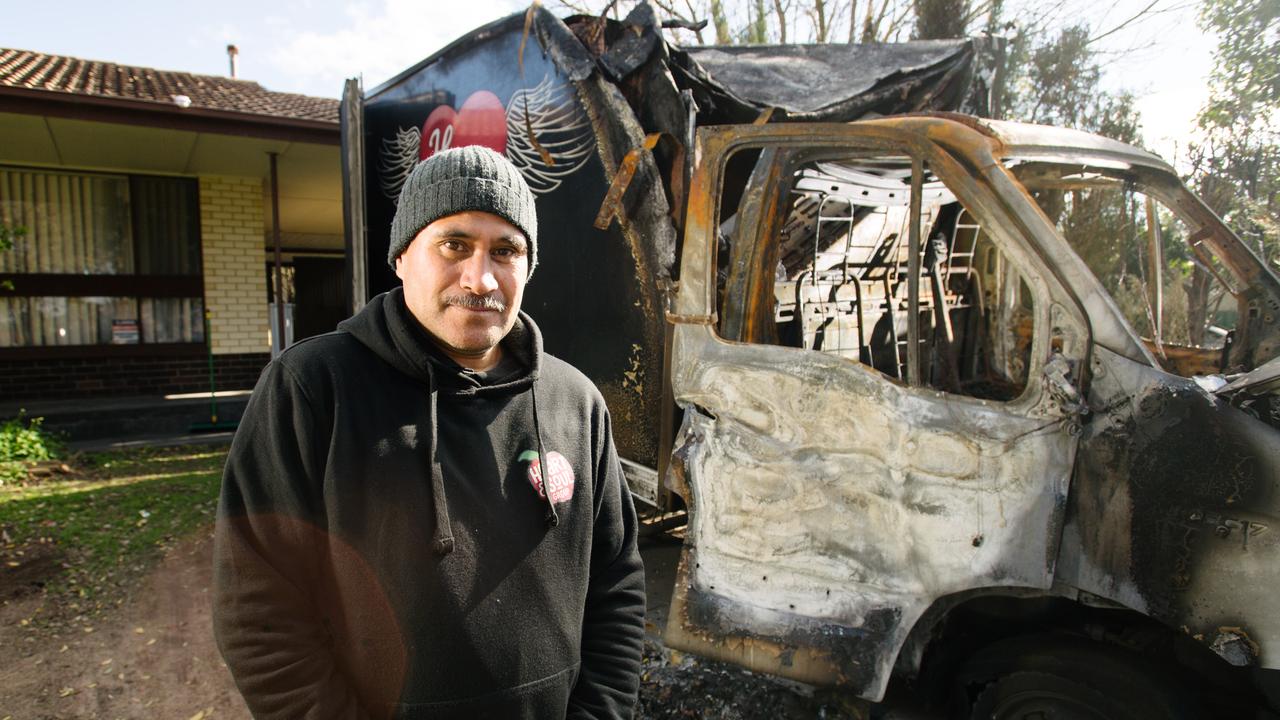 Patrick Dixon, volunteer and driver for food charity Heart and Soul Community Group, in front of the burnt out van. Picture: AAP Image/Morgan Sette