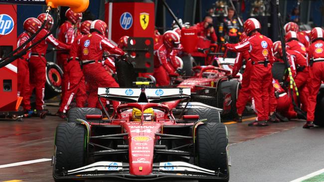 Lewis Hamilton driving out of pit lane as Charles Leclerc makes a pit stop during the Australian Grand Prix. Picture: Getty