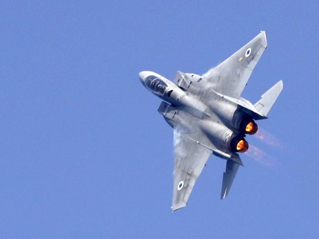 An Israeli F-15 fighter jet performs a rehearsal ahead of an air show to commemorate the 70th anniversary of the creation of Israel in May, in the coastal city of Tel Aviv on April 12, 2018.  / AFP PHOTO / JACK GUEZ