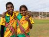 Ashley Smith, 11, and Latahnia Anderson, 10, on the newly grassed Santa Teresa Oval in the Northern Territory  on May 3, 2021.  Picture: Emma Murray