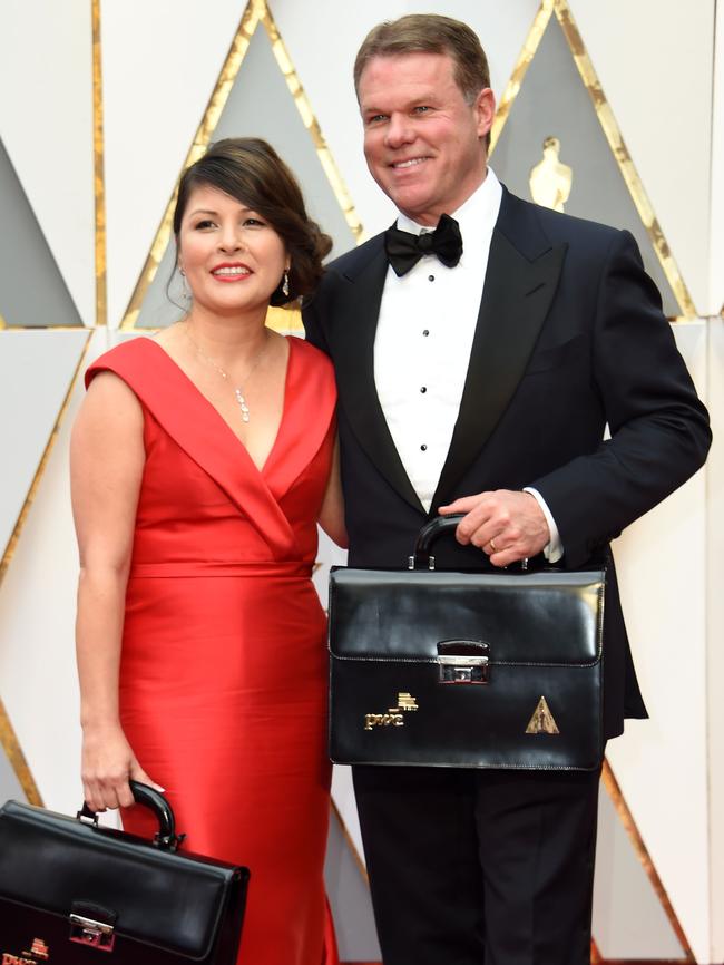 PWC reps Martha Ruiz and Brian Cullinan enter the awards with their locked bags of envelopes, knowing not the fiasco that was shortly to unfold. Picture: AFP