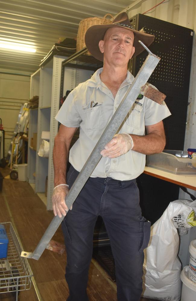 Mike Johnson shows the metal bar thieves used to break in to the Landcare nursery.