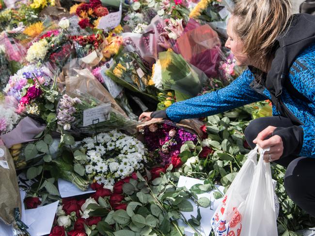 A woman lays flowers near the scene of Saturday's terrorist attack. Picture: Getty