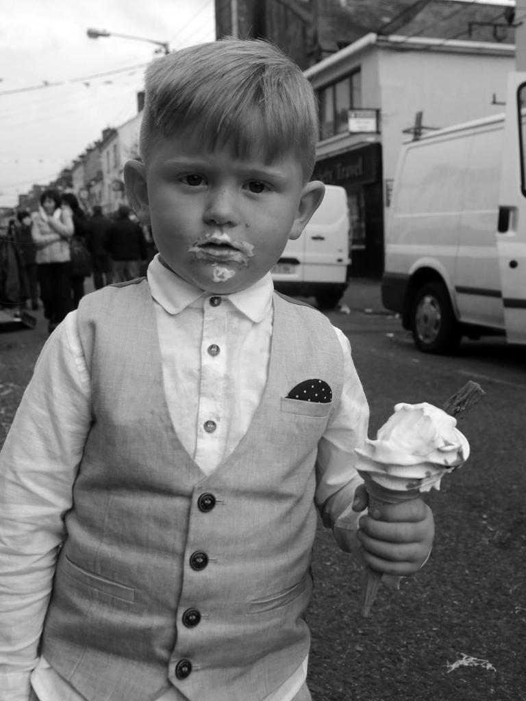 A boy takes a break from eating an ice cream to pose for a photo. Picture: Jamie Johnson