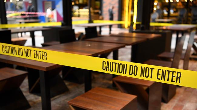 Outdoor dining areas are taped off in Melbourne after the shutdown began. Picture: Quinn Rooney/Getty Images