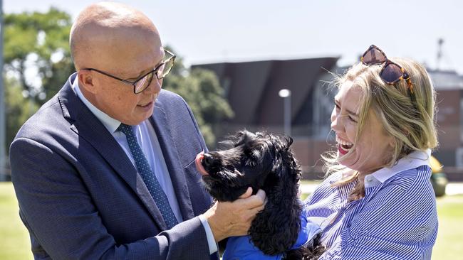 Peter Dutton with Amelia Hamer and her dog Juno in a Malvern dog park. Picture: NewsWire / David Geraghty