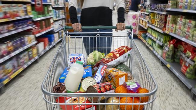 CARDIFF, WALES - MAY 22: A woman with a shopping trolley full of groceries in a supermarket aisle on May 22, 2022 in Cardiff, Wales. Last week, the UK Office for National Statistics reported an 6% average increase of food and drink prices year on year, but some staples, such as milk and pasta, had risen by more than 10%. (Photo by Matthew Horwood/Getty Images)